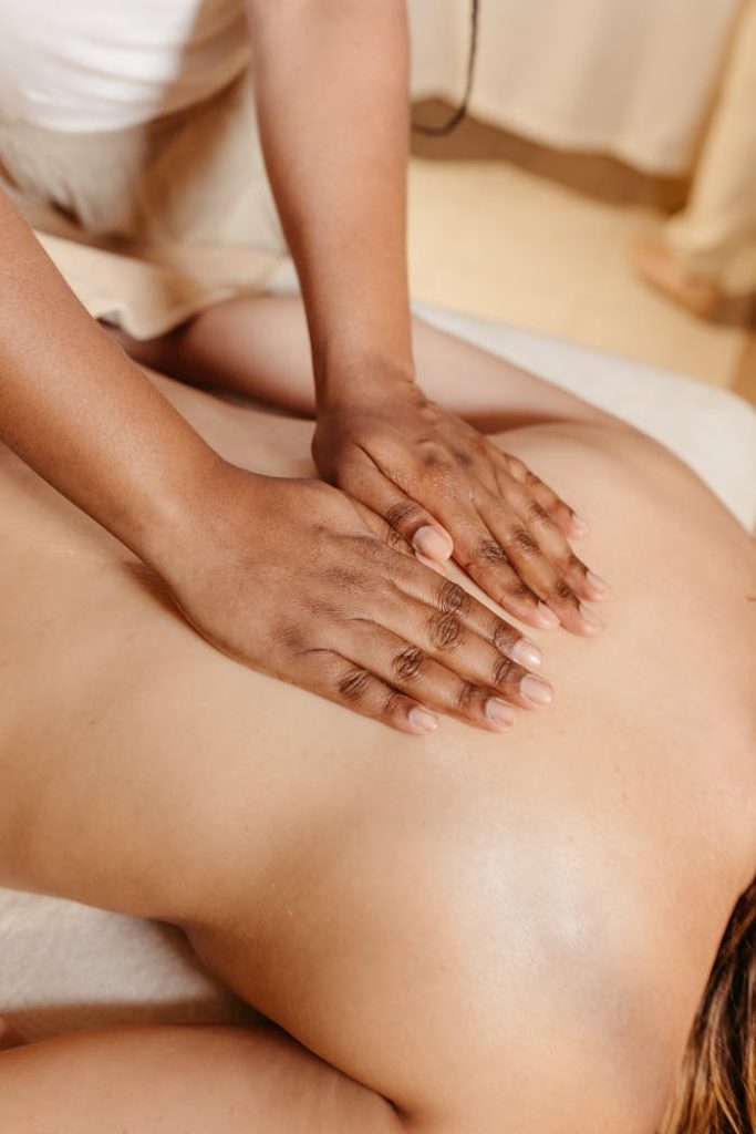 pexels-photo-19641818 Close-up of a relaxing spa massage with a therapist massaging a woman's back.