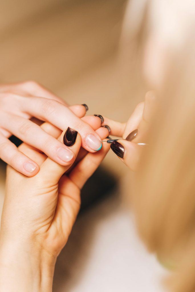 pexels-photo-4677852-4677852 Detailed view of a professional manicurist working on a client's nails, showcasing nail care.